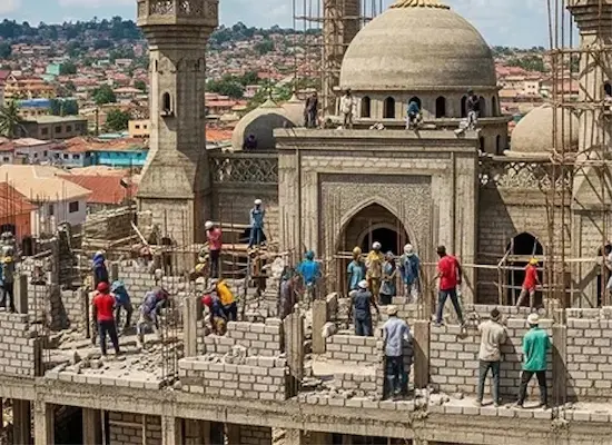 Construction workers build a large mosque as part of a Giving Hands community development project.