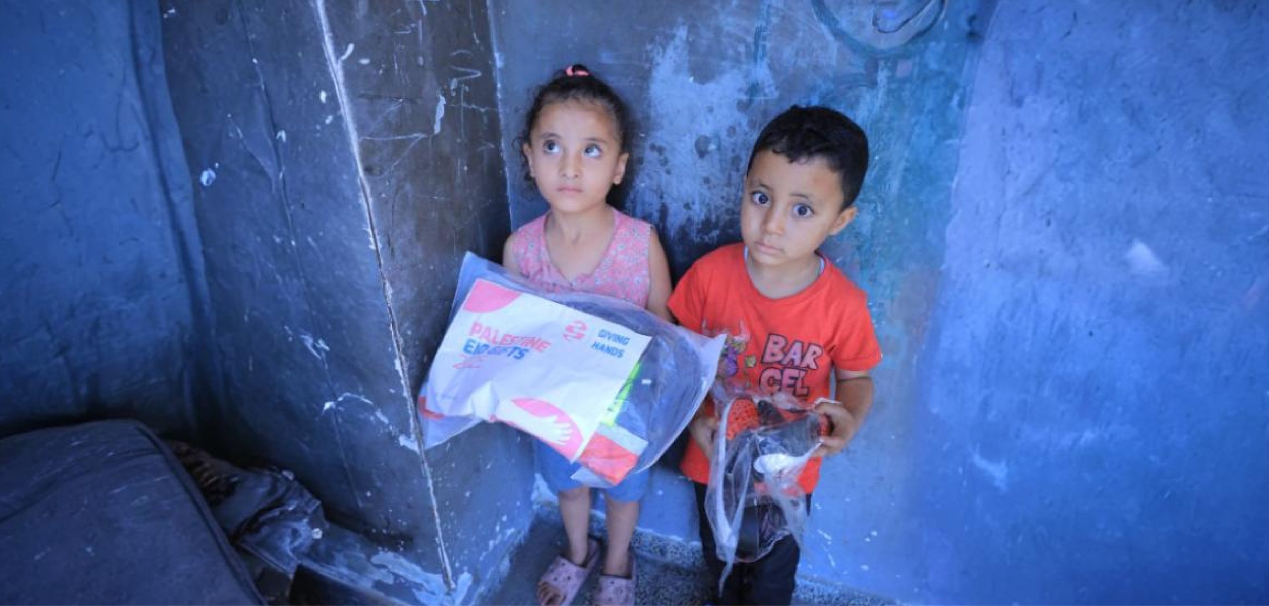 Children receiving emergency aid packages from Giving Hands Canada during Palestine crisis relief