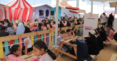 Children and families participating in a community event organized by Giving Hands in Palestine