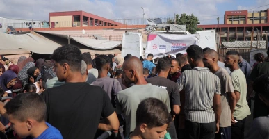 Crowd of people gathered at a Giving Hands outdoor food distribution